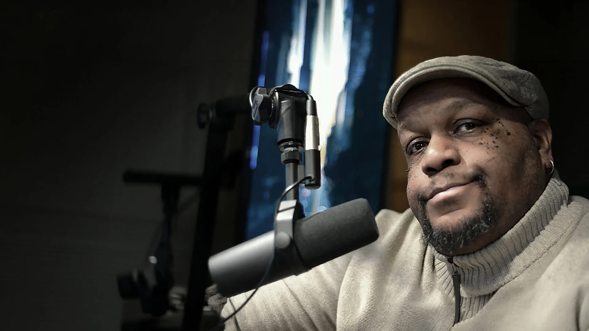 Tucker speaking into a studio microphone.