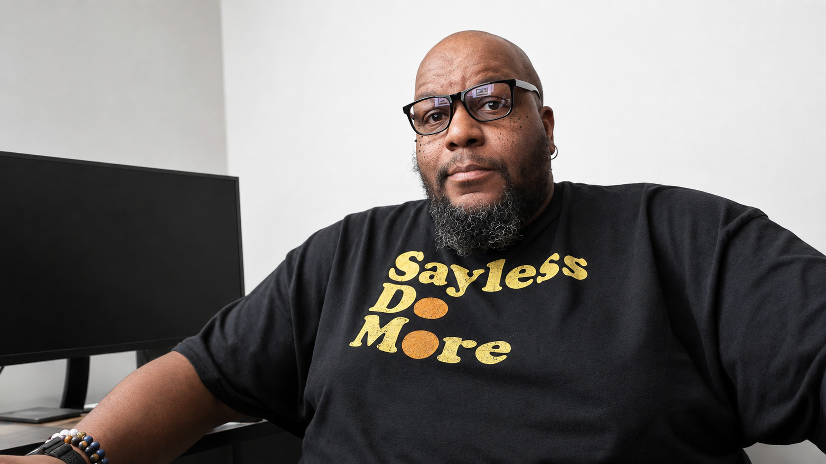 Uncle Tuck wearing a Sayless - Do more black tshirt